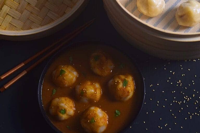 dark and moody photo of vegan gluten free jhol momos in a bowl