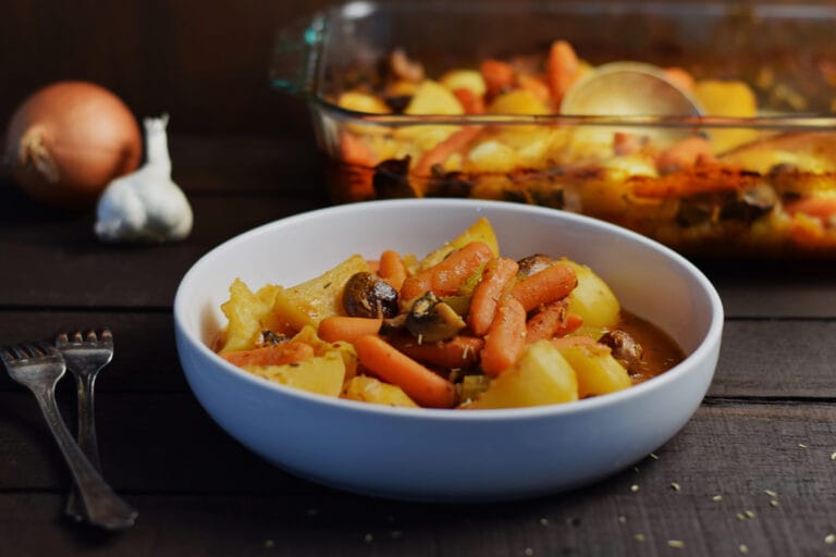 vegan pot roast in a white bowl on a wooden table